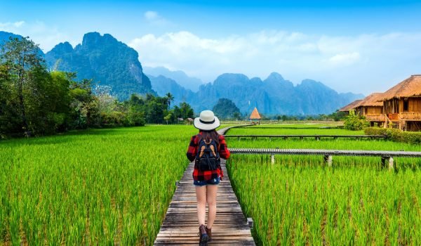 tourism-with-backpack-walking-wooden-path-vang-vieng-laos