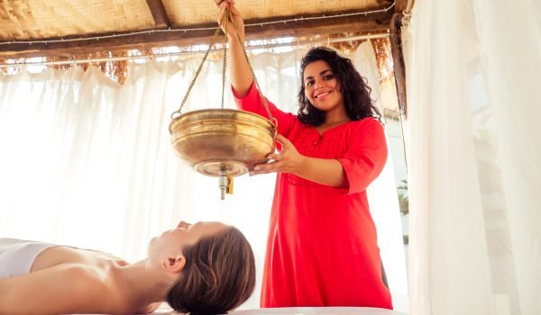 young woman doing healthcare indian traditional treatment in Ayurveda body constitution centre.